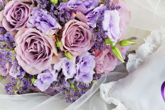 bride bouquet of purple flowers on white background